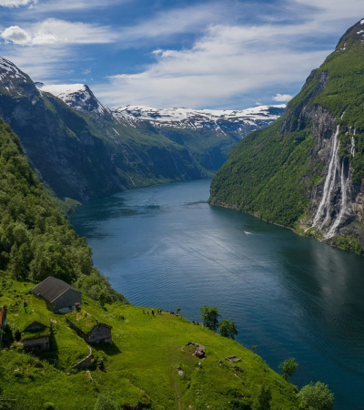 A river running through a valley between mountains in Norway
