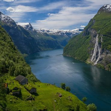 A river running through a valley between mountains in Norway