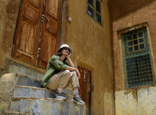 a man sitting on steps in front of a building