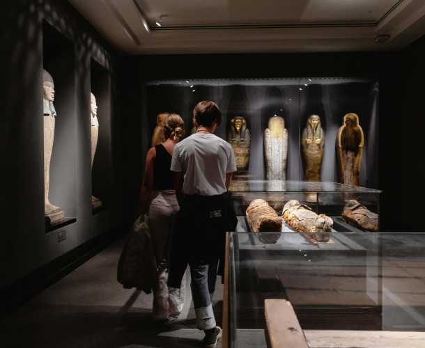 Visitors explore Egyptian artifacts at a museum in Copenhagen.