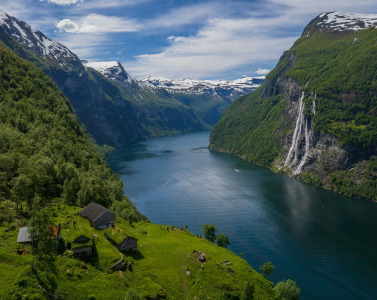 A river running through a valley between mountains in Norway