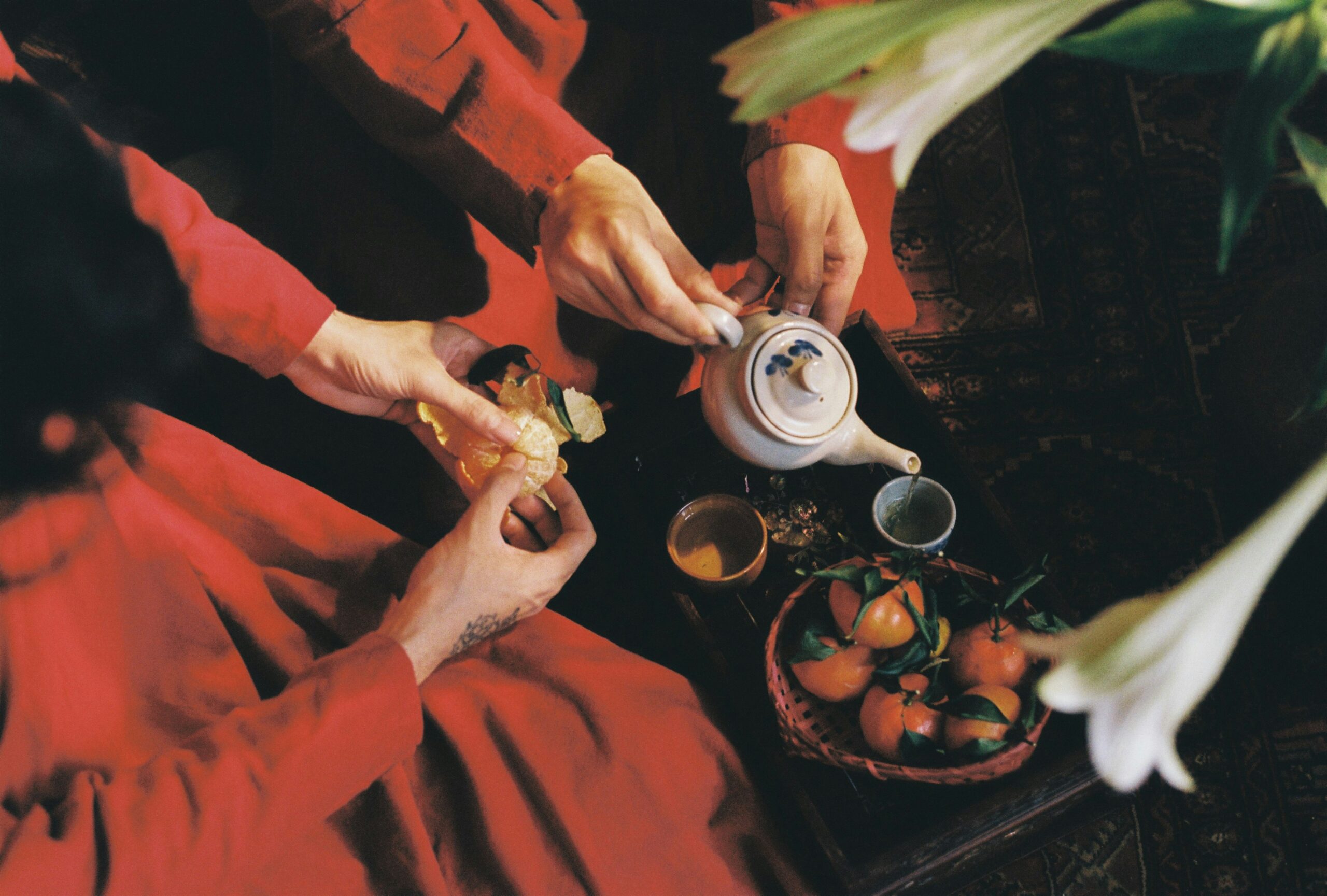Tea Ceremony Bhutan, a woman in a red dress is pouring tea