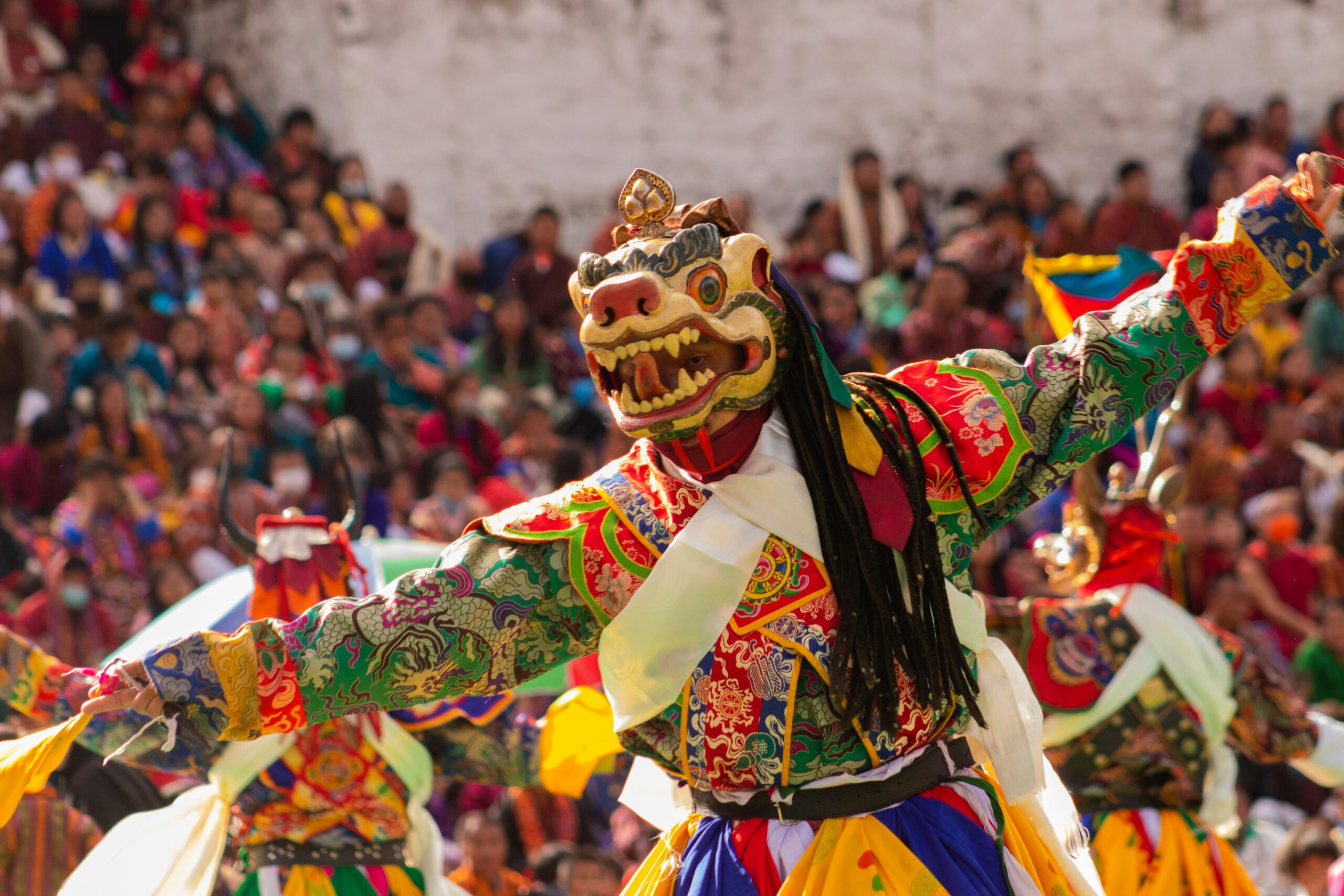 Festival in Bhutan, a person in a garment with a crowd watching