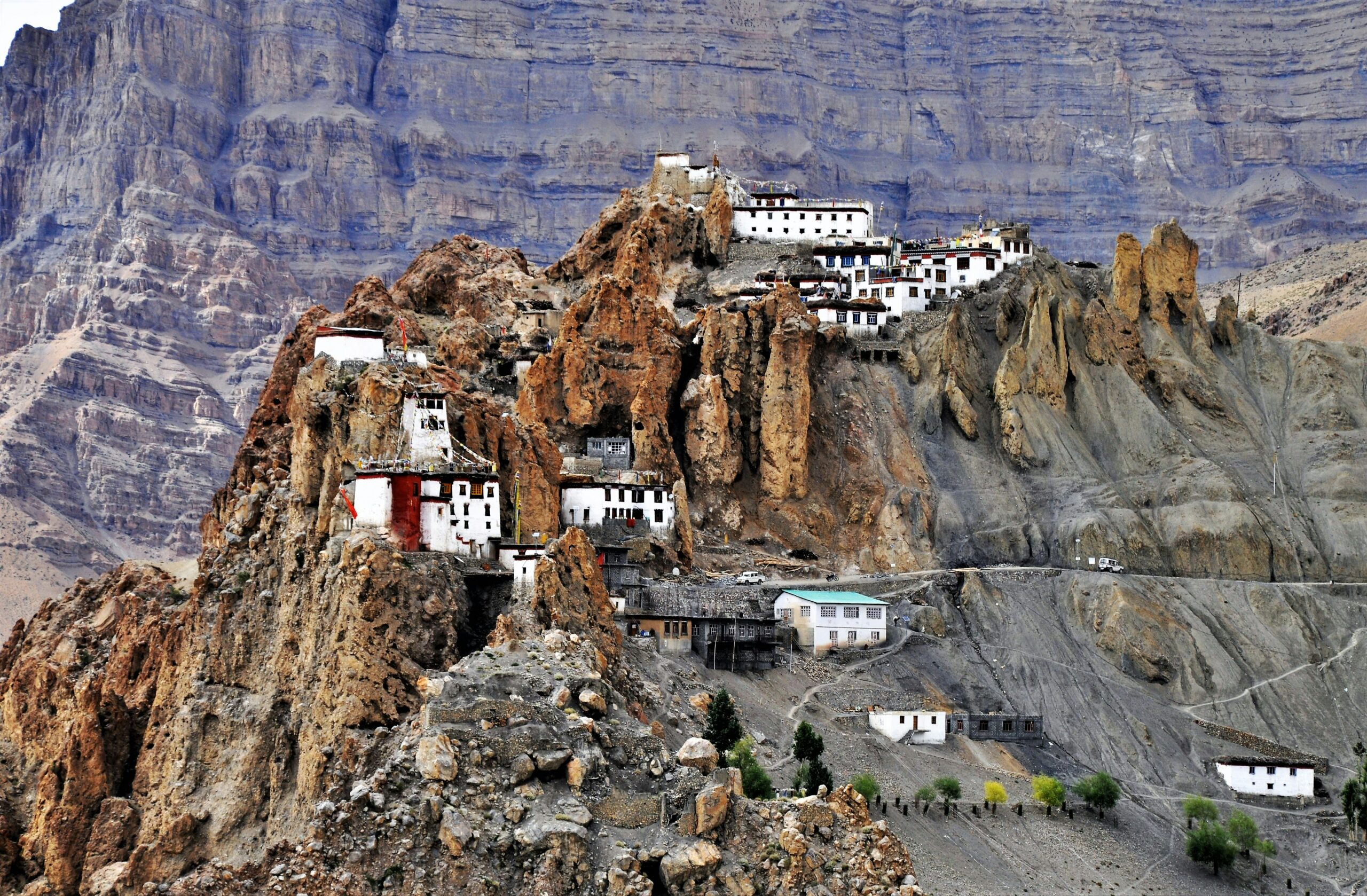 Bhutan landscape, white and blue building on brown rocky mountain during daytime