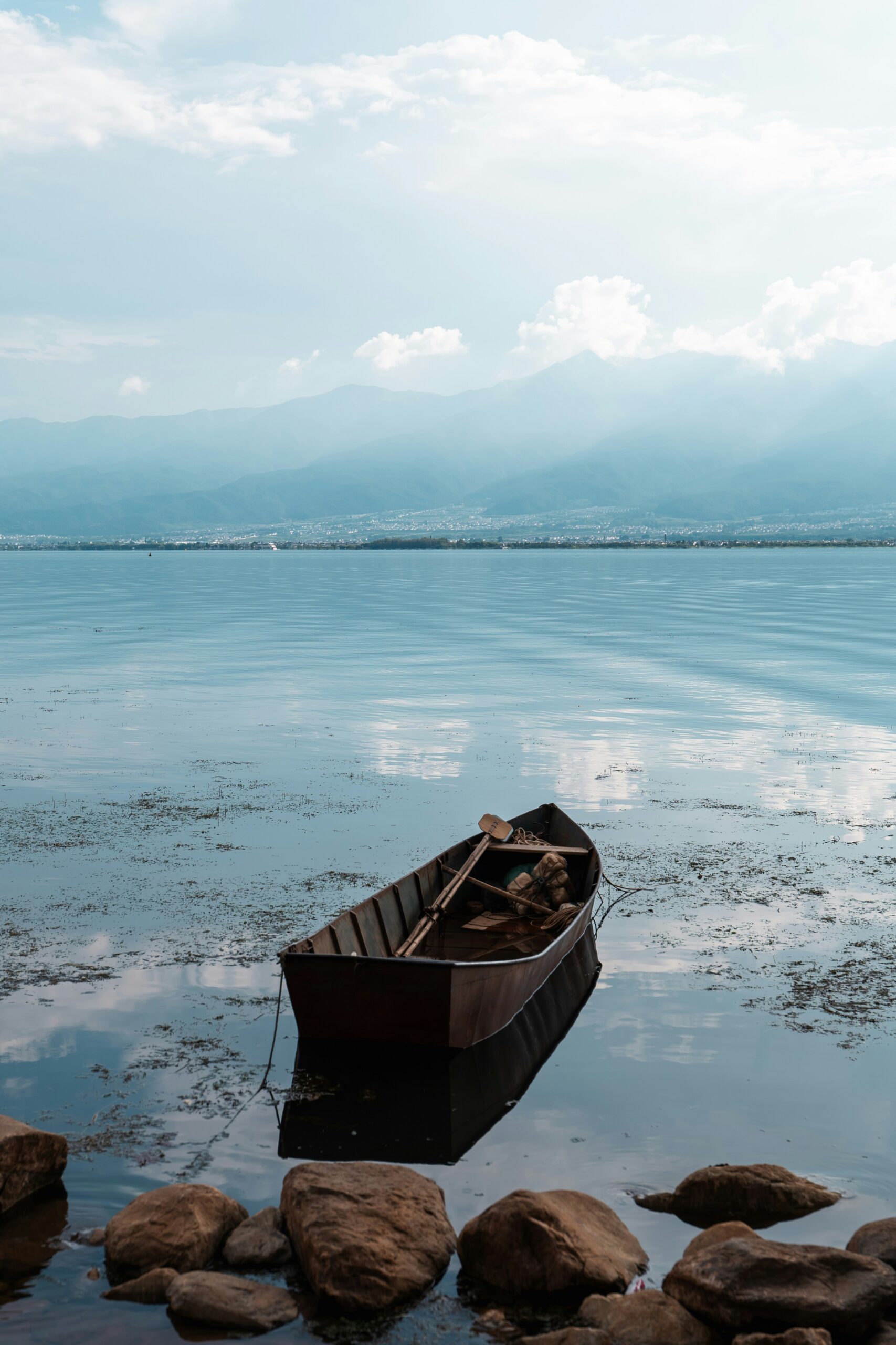 A small boat floating on top of a body of water