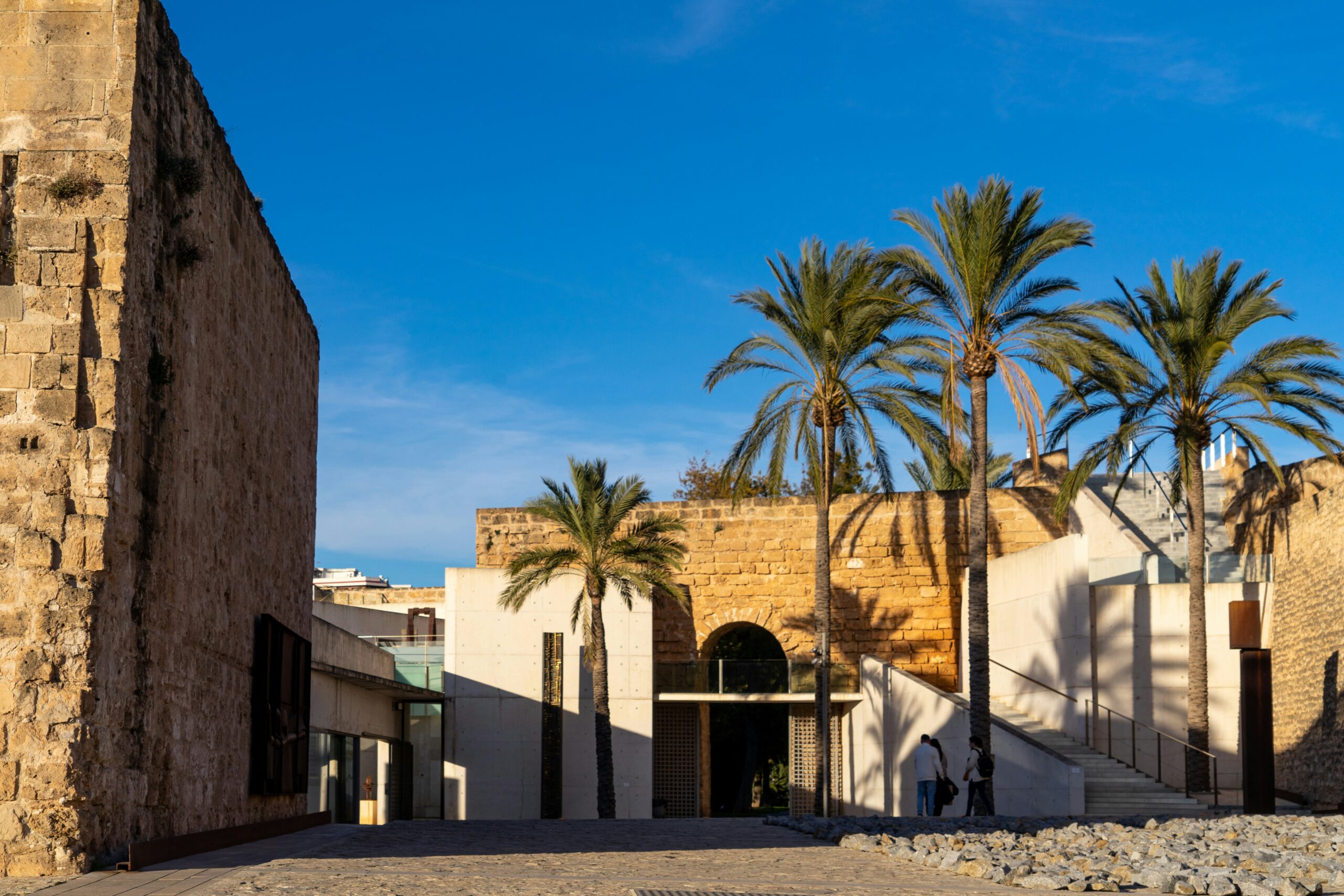 a building with palm trees in front of it