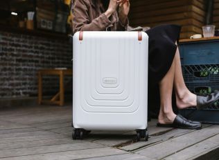 person in white pants lying on blue and red hammock