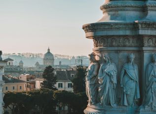 yellow and black motor scooter parked beside brown concrete building during daytime