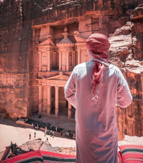 a man standing in front of a cliff