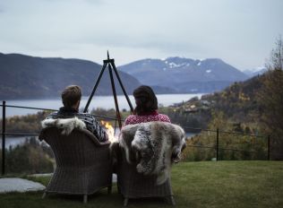 brown wooden bench on dock near lake during daytime
