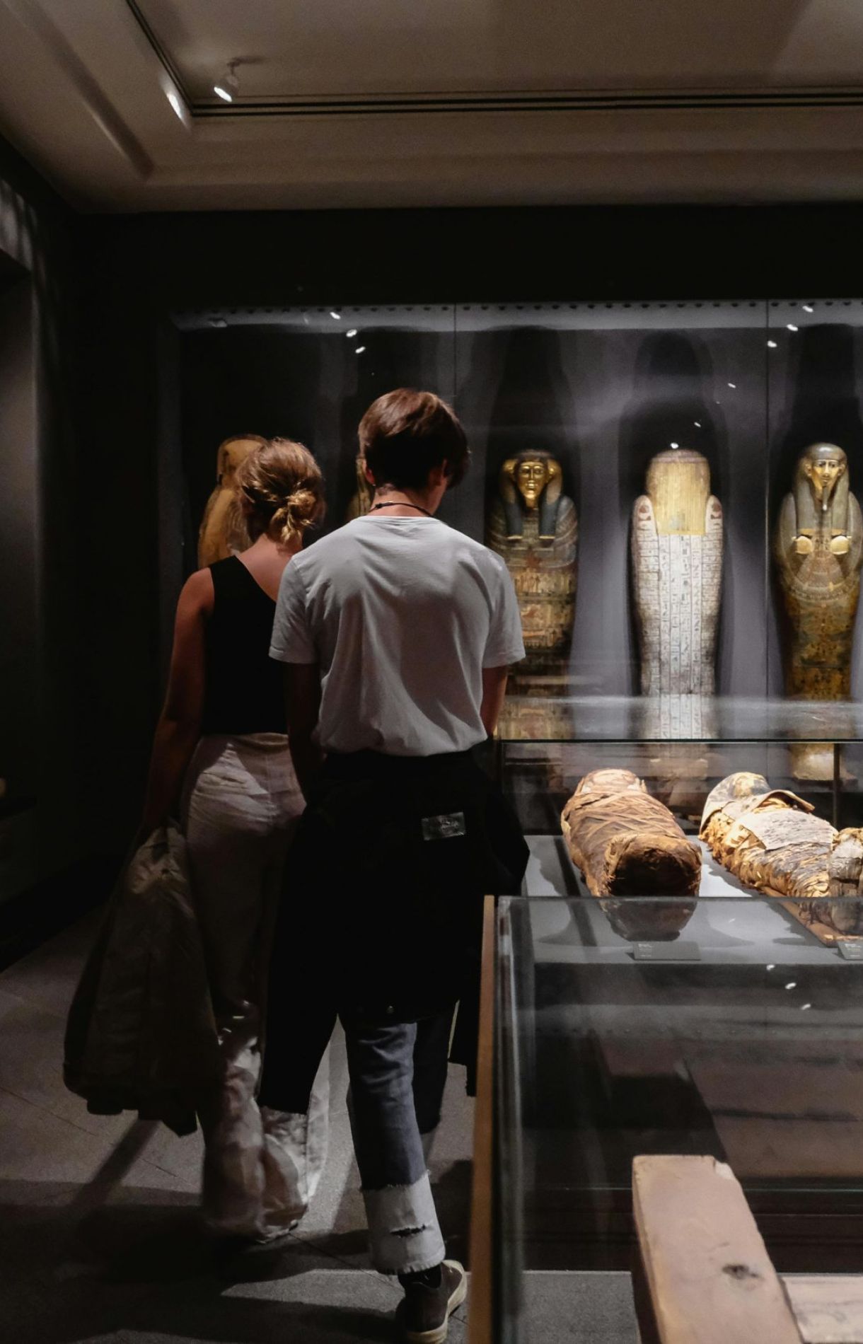 Visitors explore Egyptian artifacts at a museum in Copenhagen.
